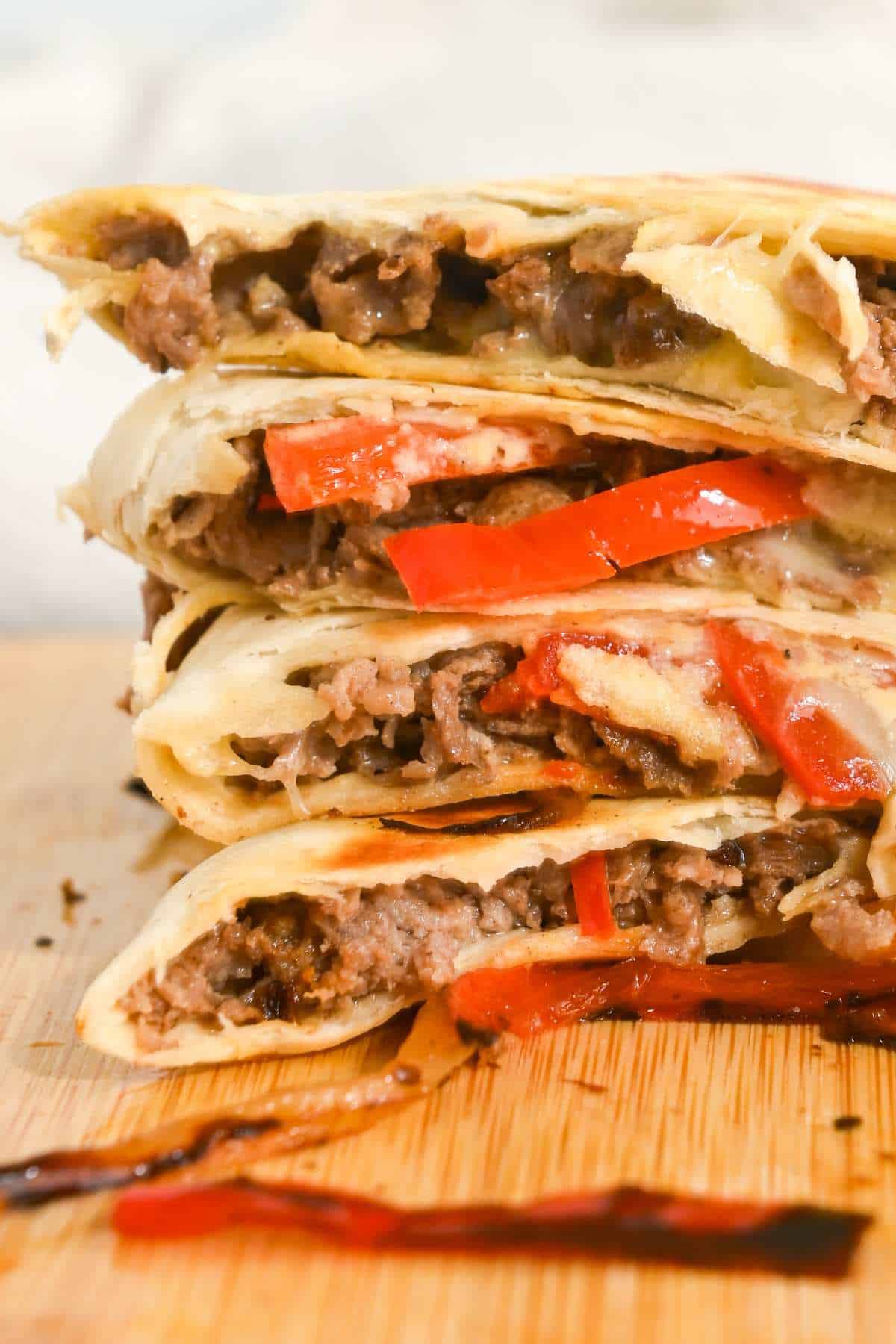 stack of beef steak quesadillas on a wooden board.