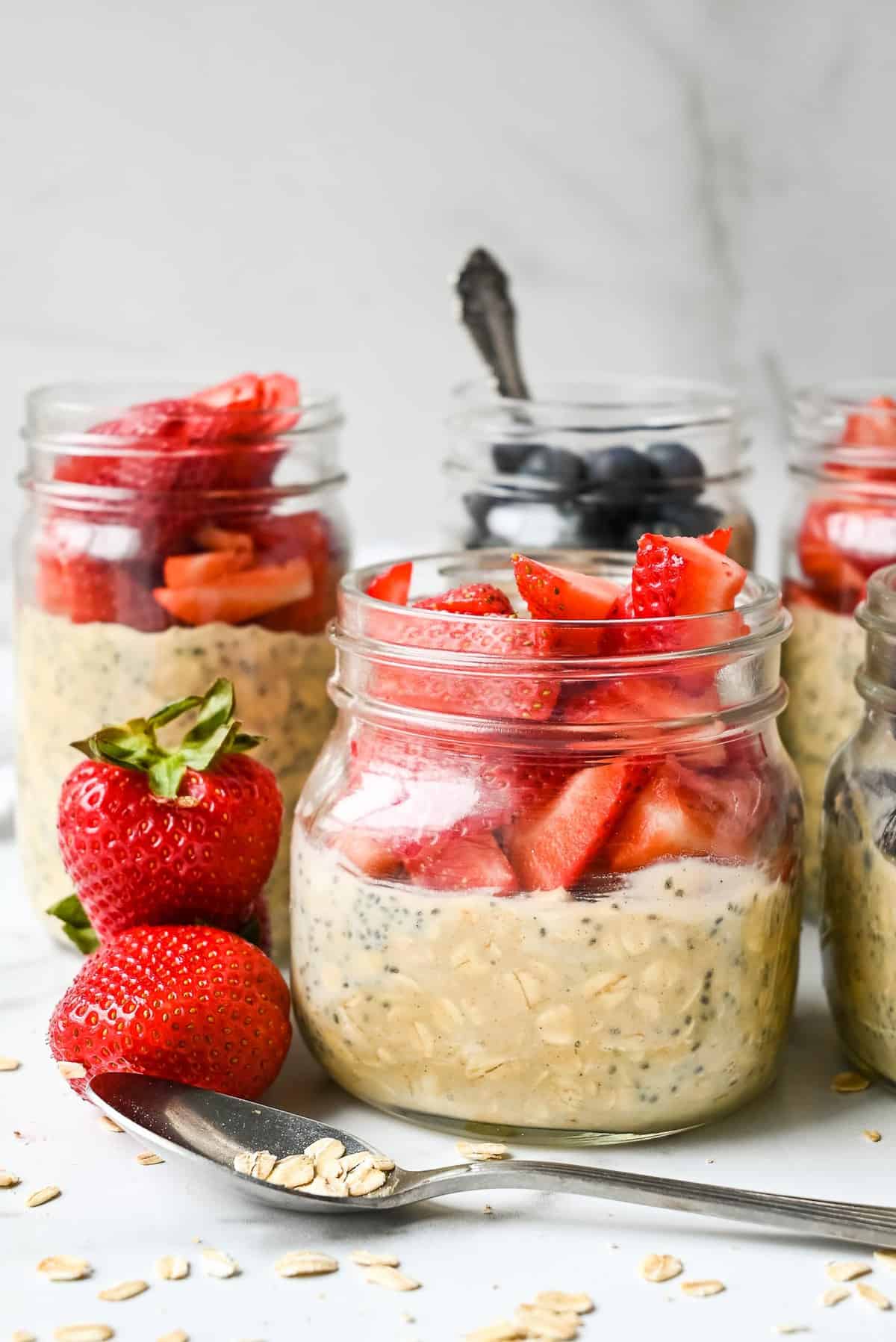 overnight oats in jars topped with berries