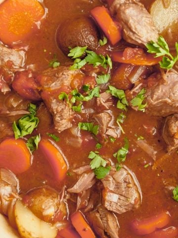 whole30 beef stew with potatoes, carrots and onions in a dutch oven