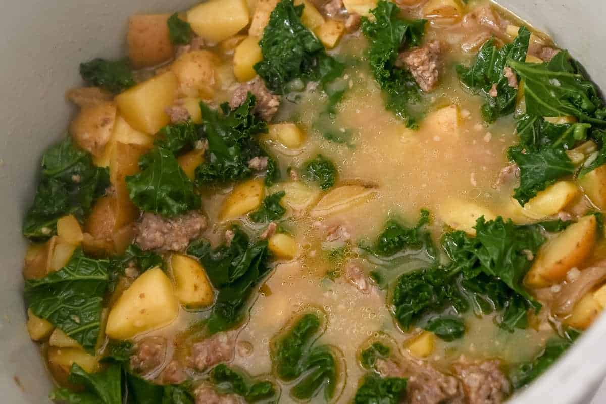 close up of cooked potato soup with kale.