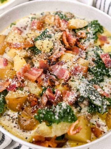 close up of instant pot chunky potato soup in a white bowl.