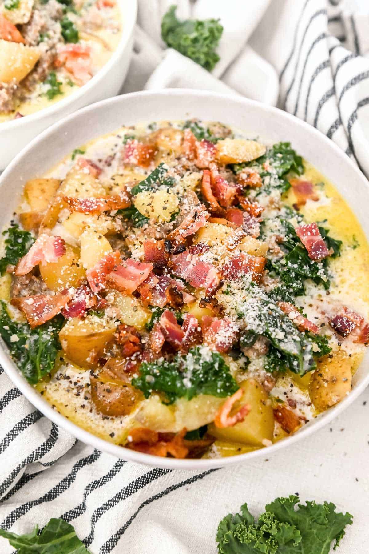 full bowl of potato soup on a striped towel.