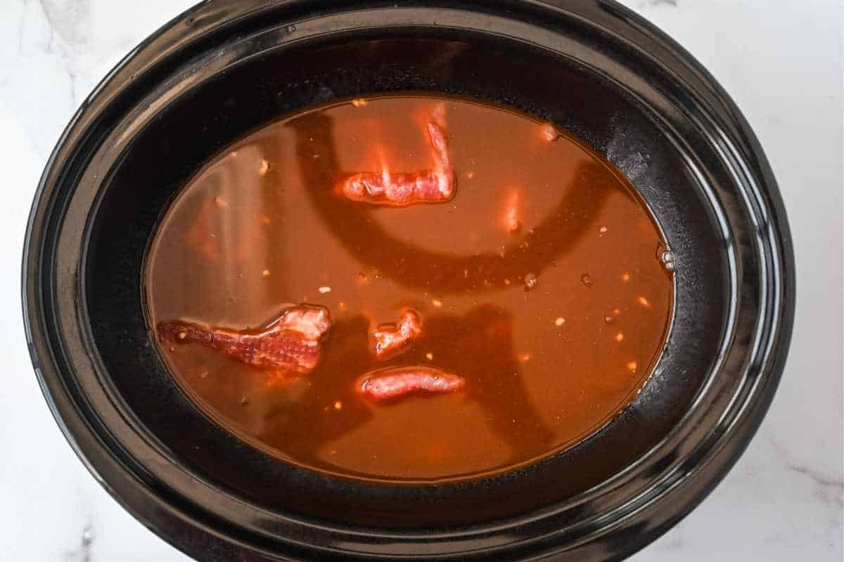 crock pot pulled pork covered with sauce.