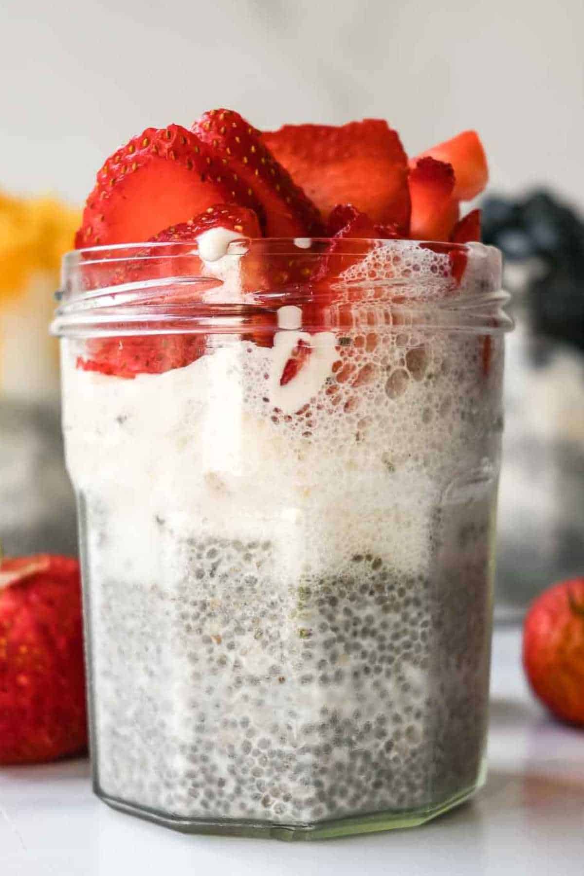 jar of chia pudding topped with strawberries.