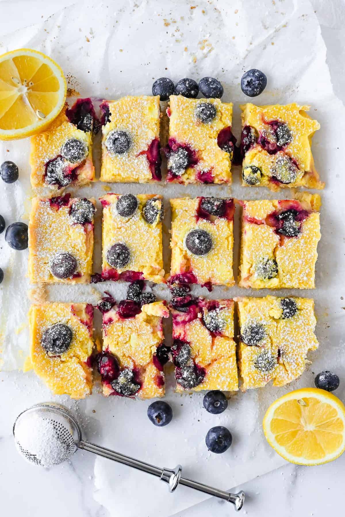 blueberry lemon bars on parchment paper