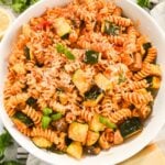 overhead view of chicken sausage pasta in a white bowl.