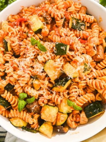 overhead view of chicken sausage pasta in a white bowl.