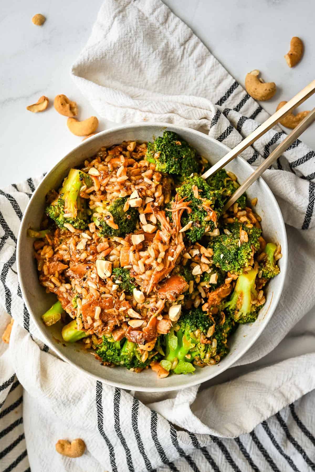 bowl of honey garlic chicken thighs stir fry with broccoli and cashews