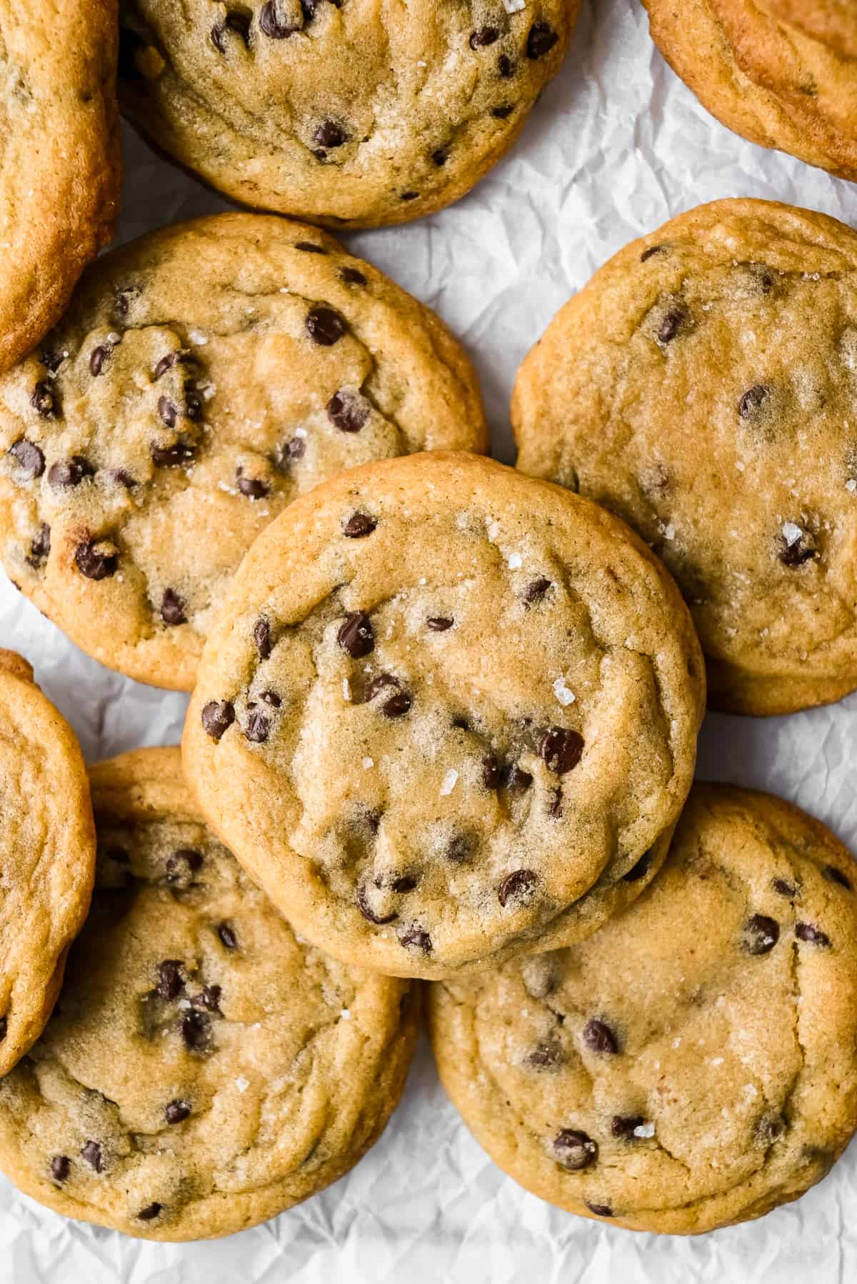 batch of dairy free chocolate chip cookies on parchment paper.