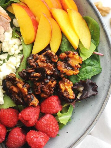 close up of raspberry chicken salad in a gray bowl.