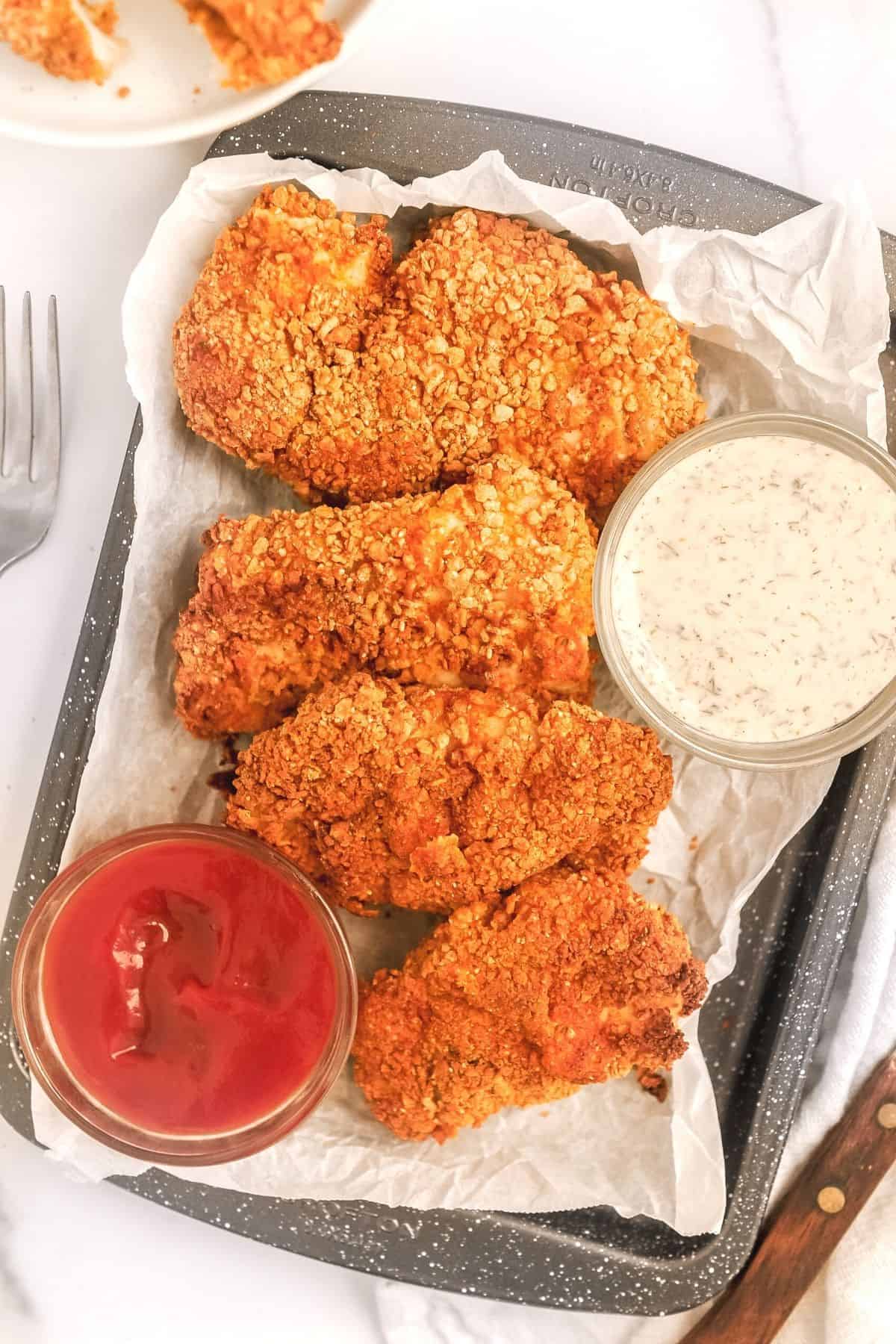 pancake chicken on a platter with dipping sauces