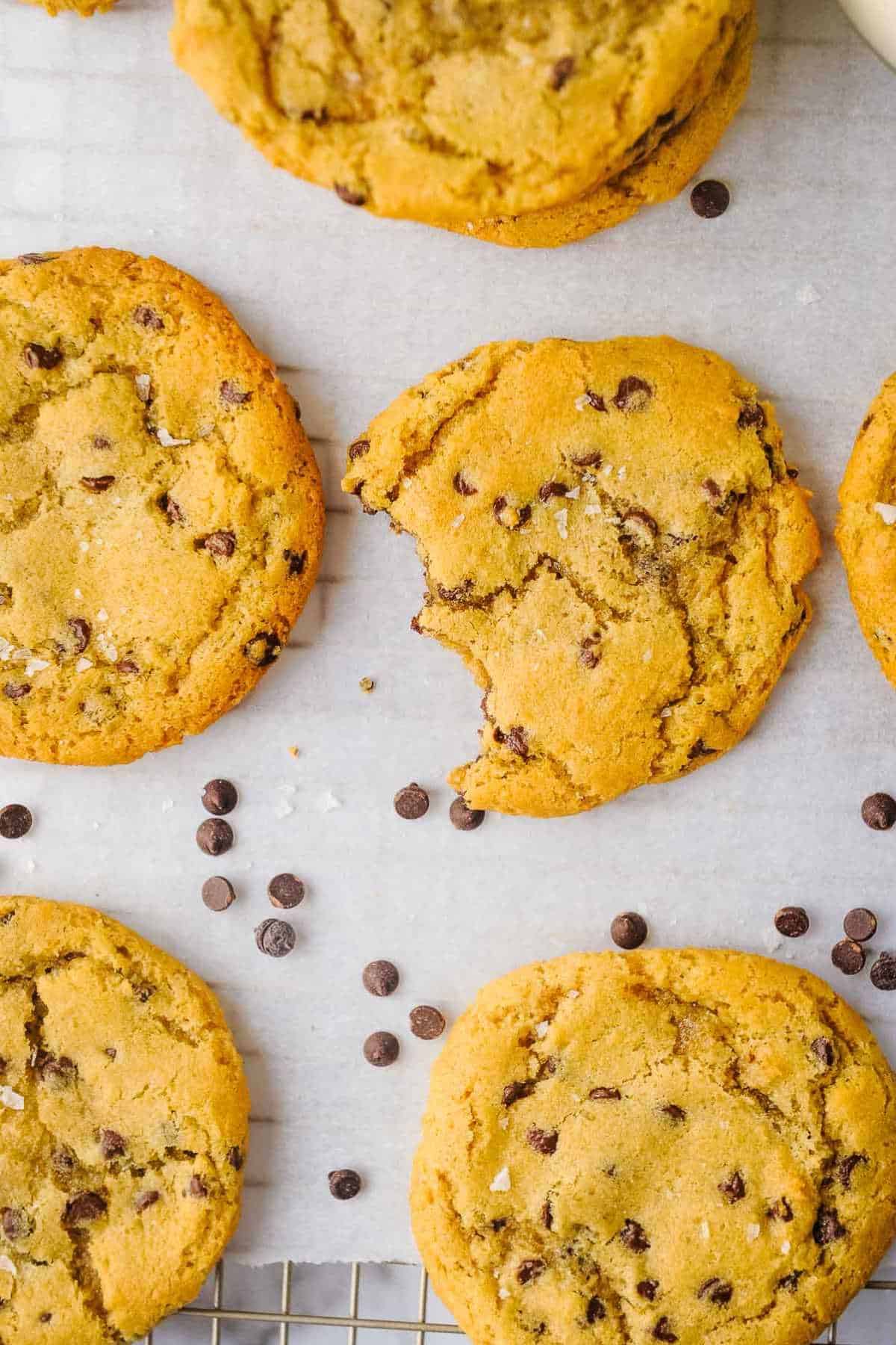 top view of cookies laying on a white background with chocolate chips.