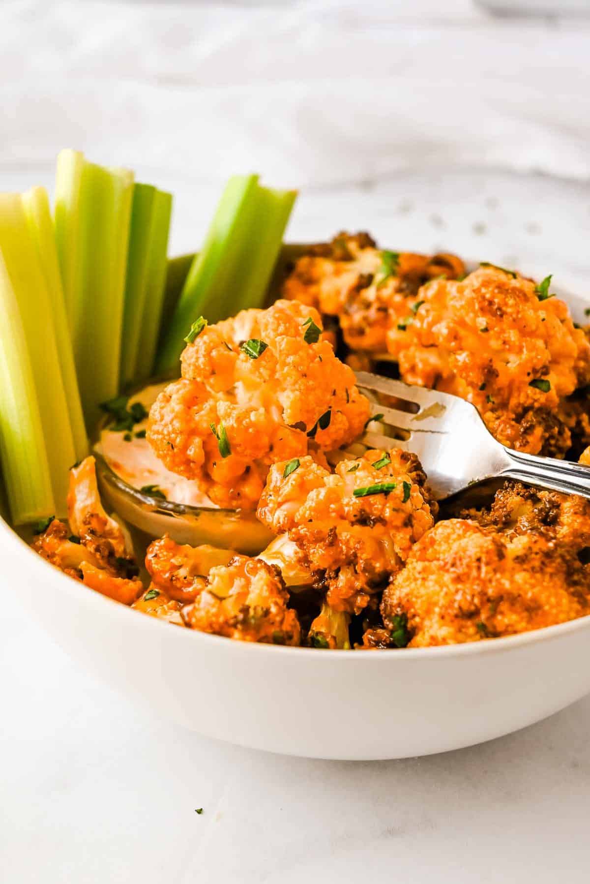 air fryer buffalo cauliflower on a fork