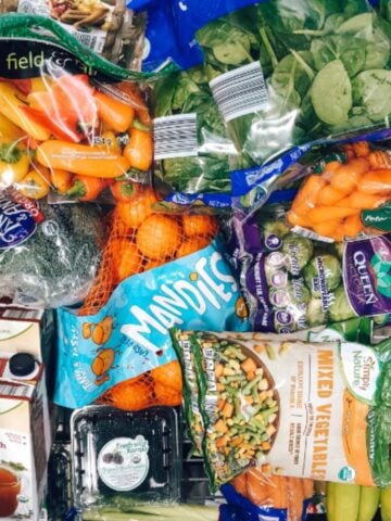 aldi shopping cart filled with whole30 approved food.