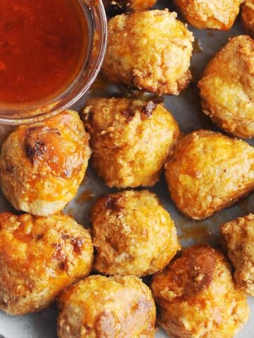 plate of buffalo meatballs with sauce on the side.