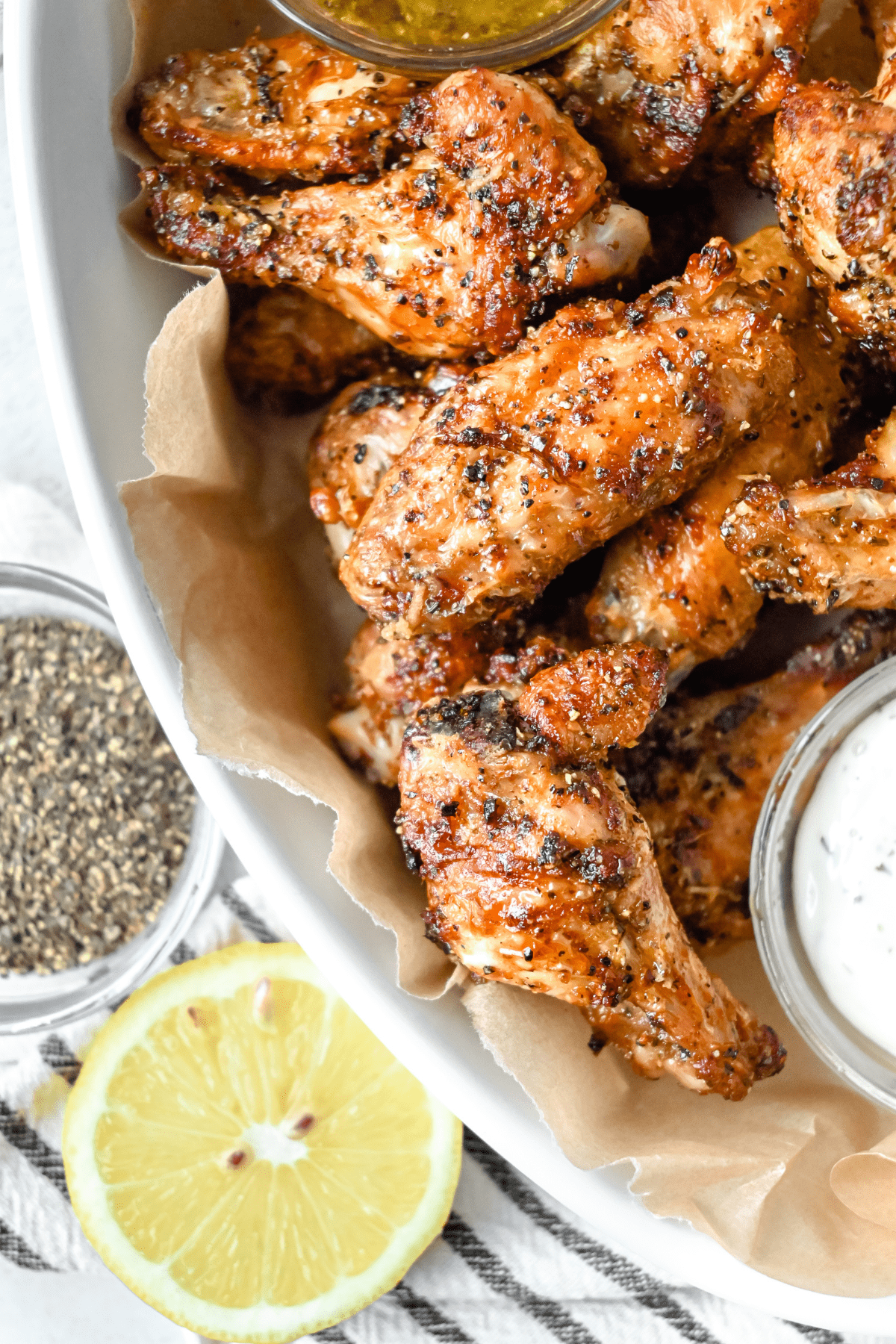 air fryer lemon pepper wings with ranch dip in a bowl