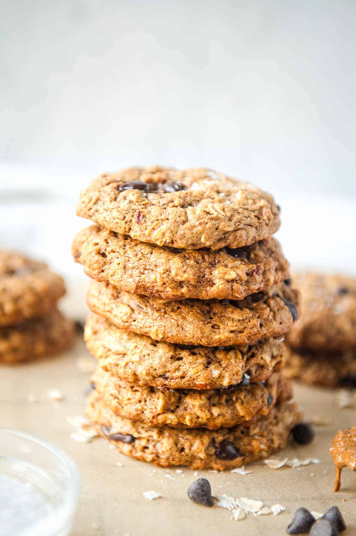 stack of oatmeal almond butter cookies on parchment paper