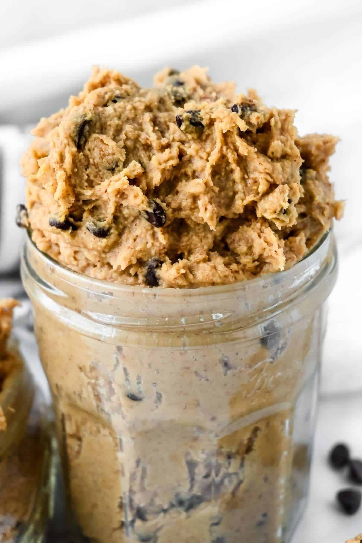 jar of chickepea cookie dough with chocolate chips.
