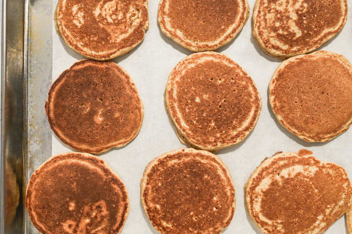 nine frozen pancakes on a sheet pan on parchment paper.