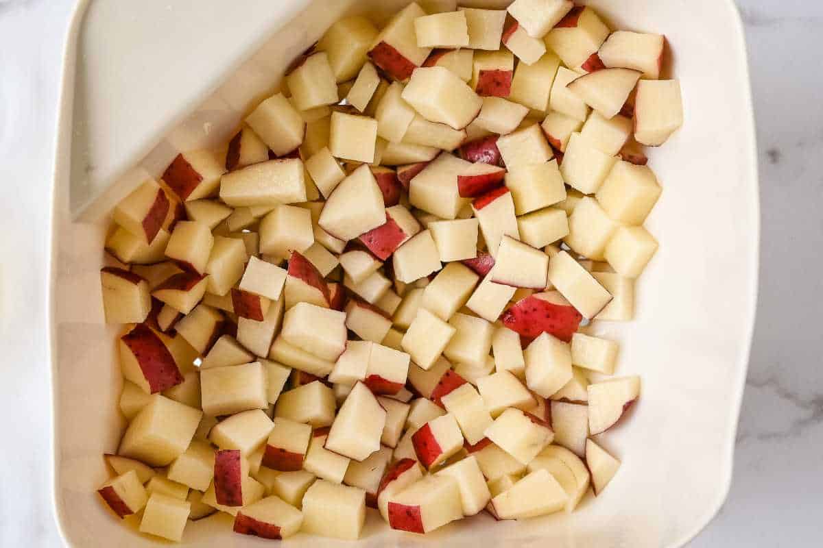 diced red potatoes in a white colander.