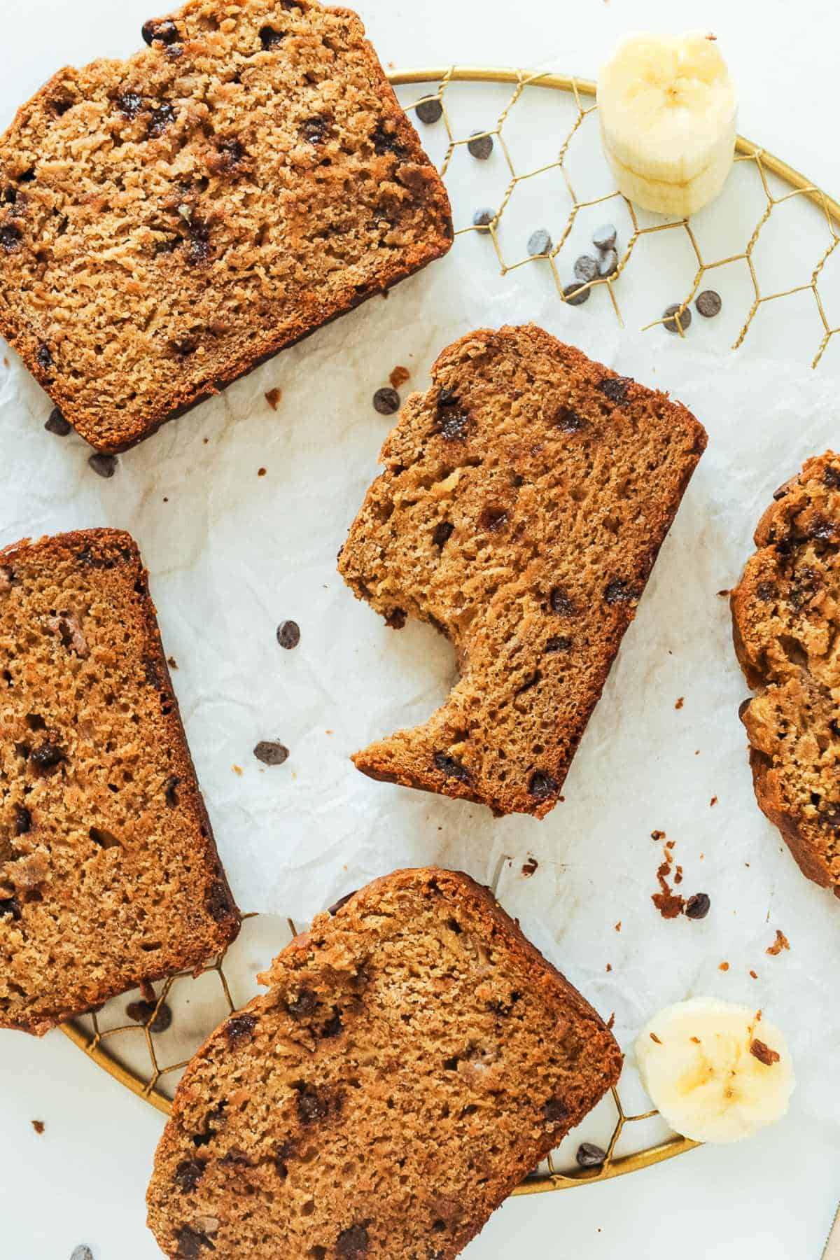 banana bread with chocolate chips slices on parchment paper.