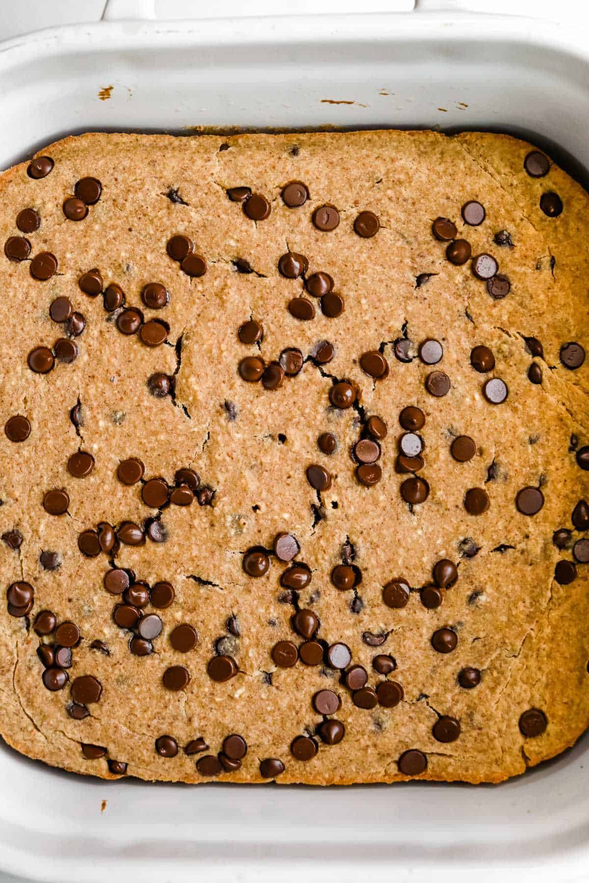 full pan of protein baked oatmeal in a white dish topped with chocolate chips.