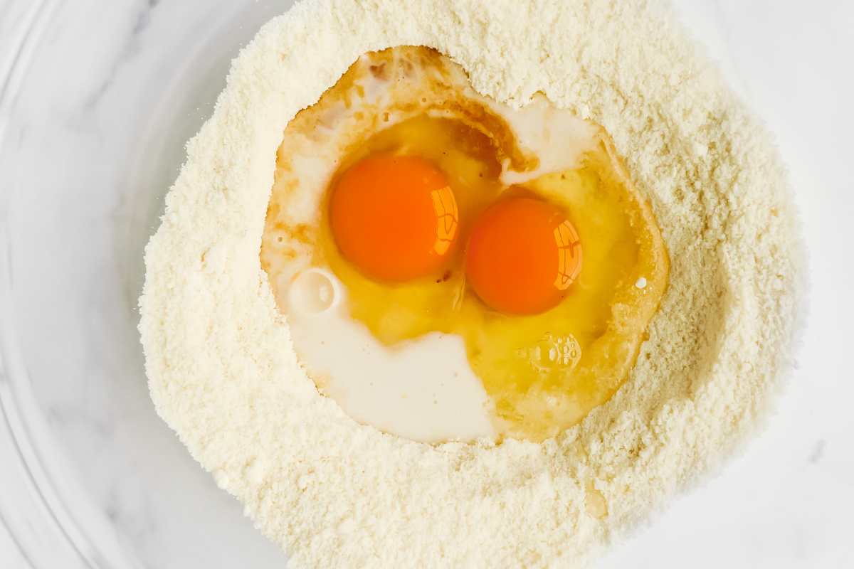 wet and dry keto donut ingredients in a glass bowl.