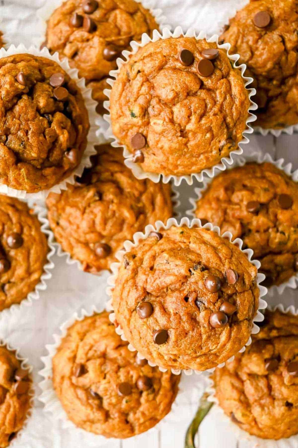 top-down view of a stack of pumpkin zucchini muffins.