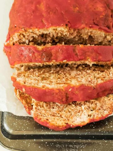 slices of homemade meatloaf topped with ketchup.