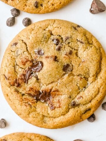 close up shot of oat flour chocolate chip cookies on a white background.