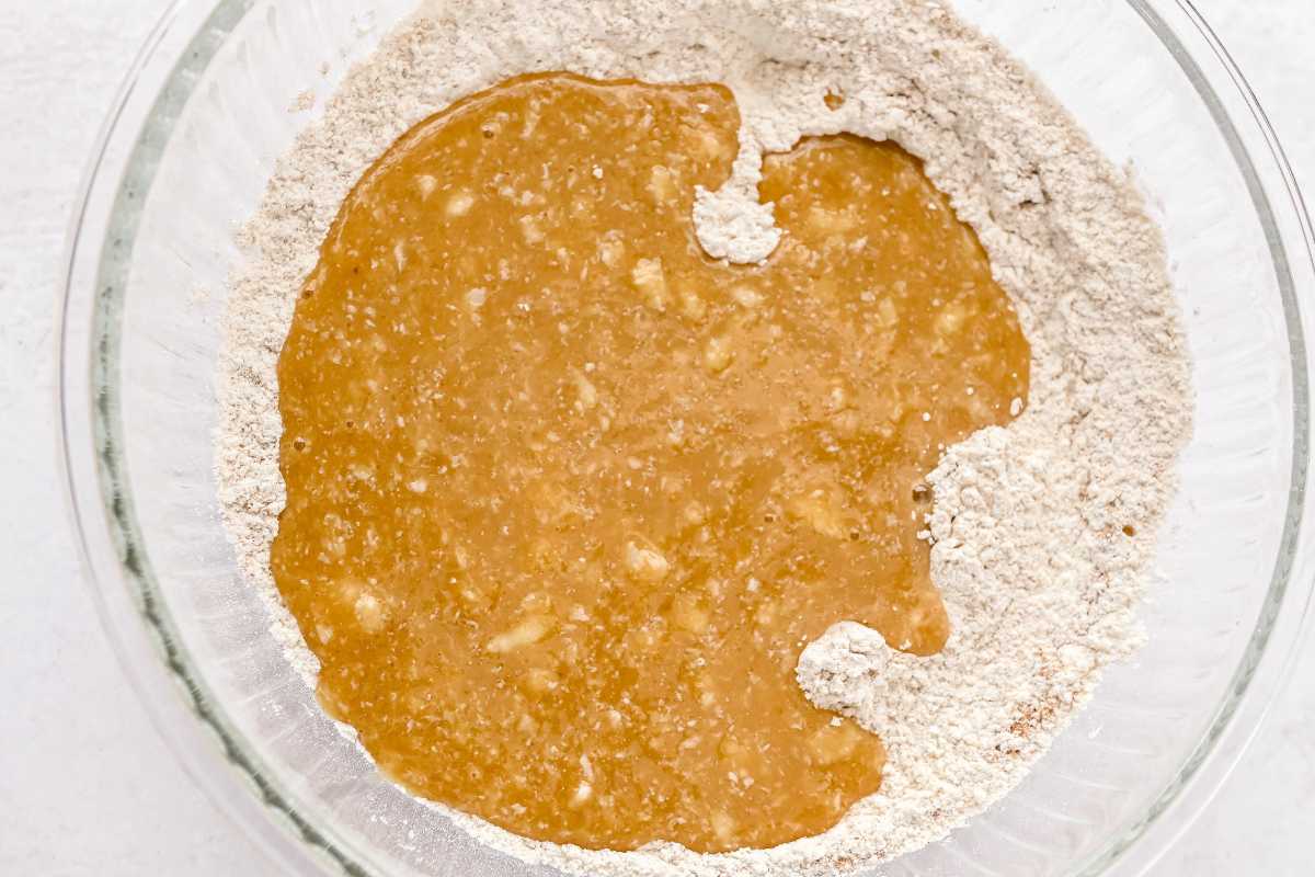 wet ingredients into dry ingredients in a glass bowl.