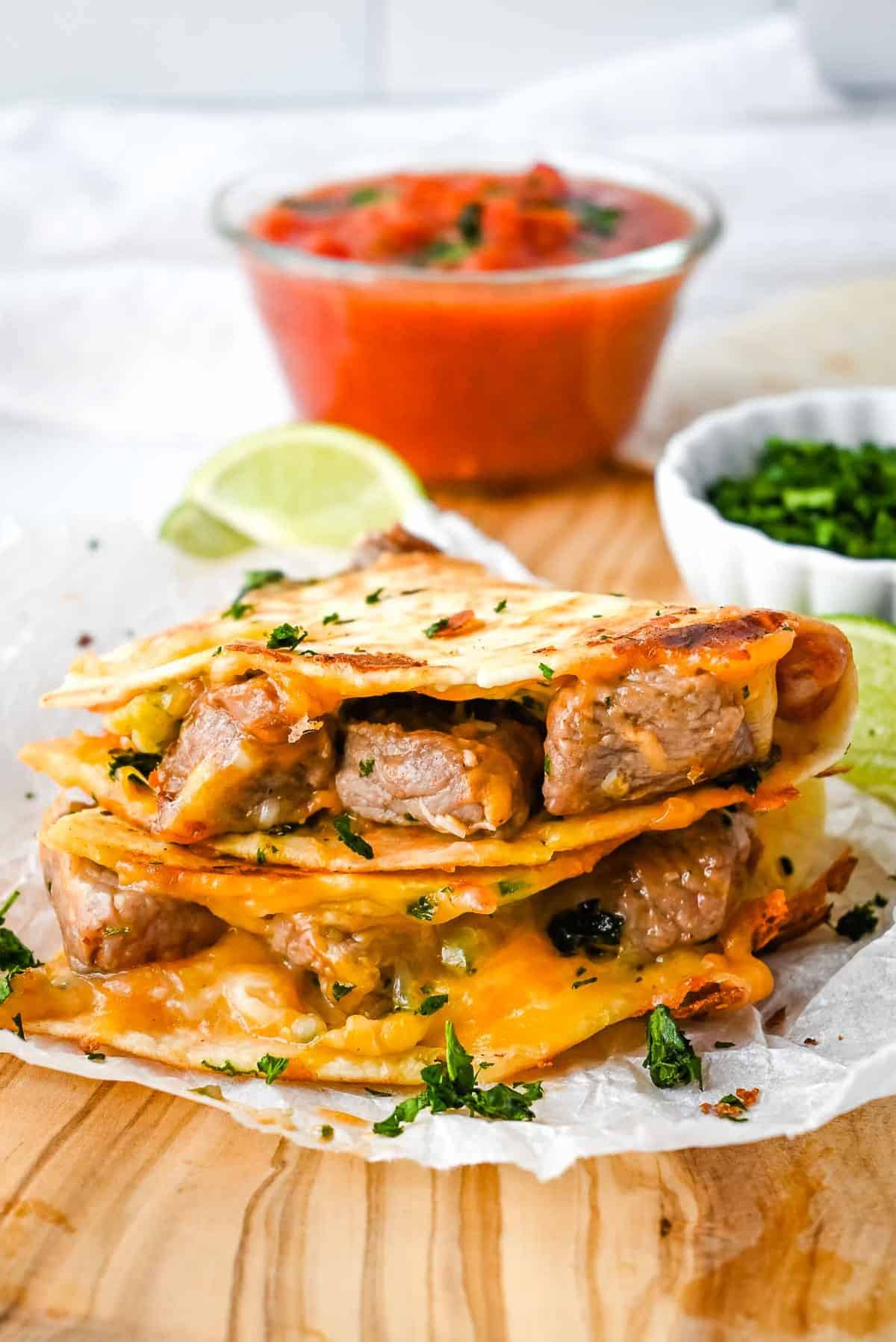 inside of carne asada quesadilla showing steak and cheese inside a tortilla