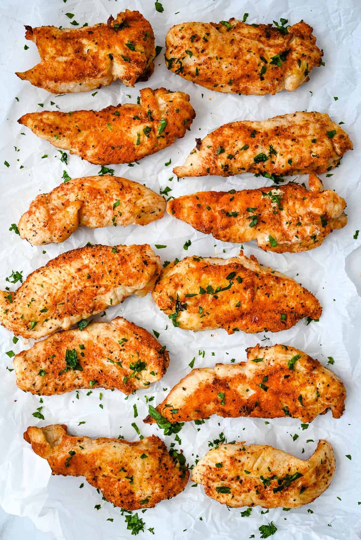 unbreaded air fryer chicken tenders with parsley.
