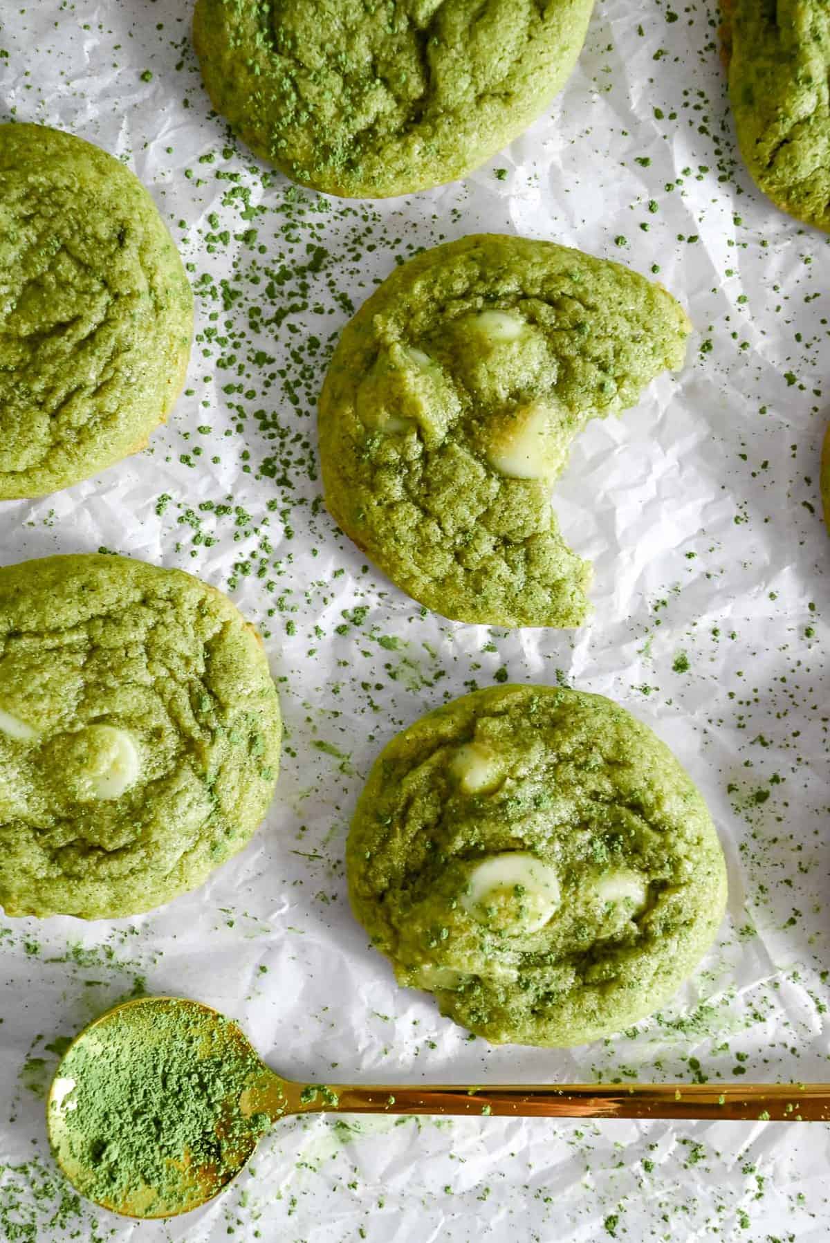 matcha cookies on parchment paper with bite shot