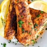 close up of air fryer mahi mahi topped with parsley and fresh lemon.