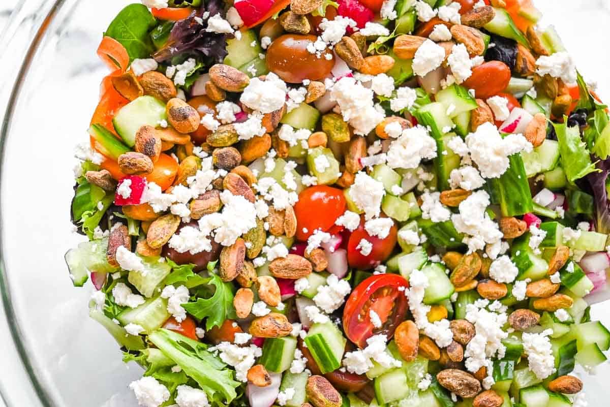 green salad with vegetables cheese and pistachios