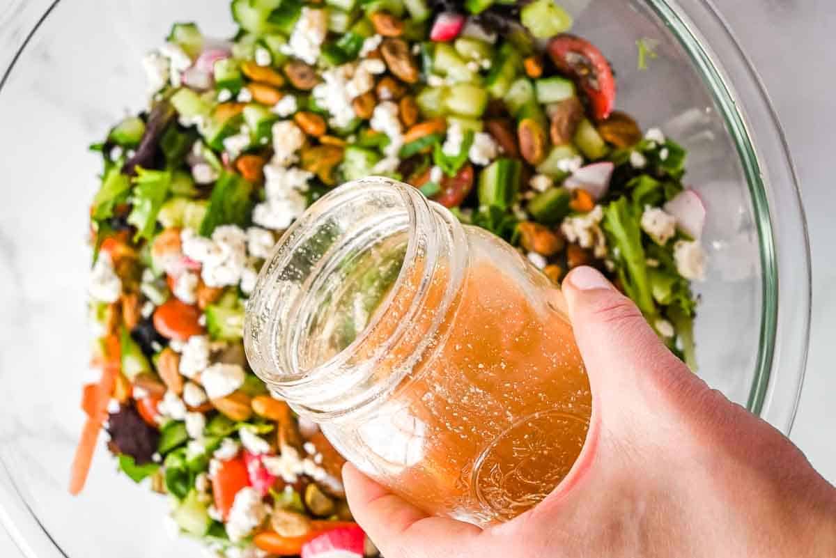 homemade salad dressing over a salad