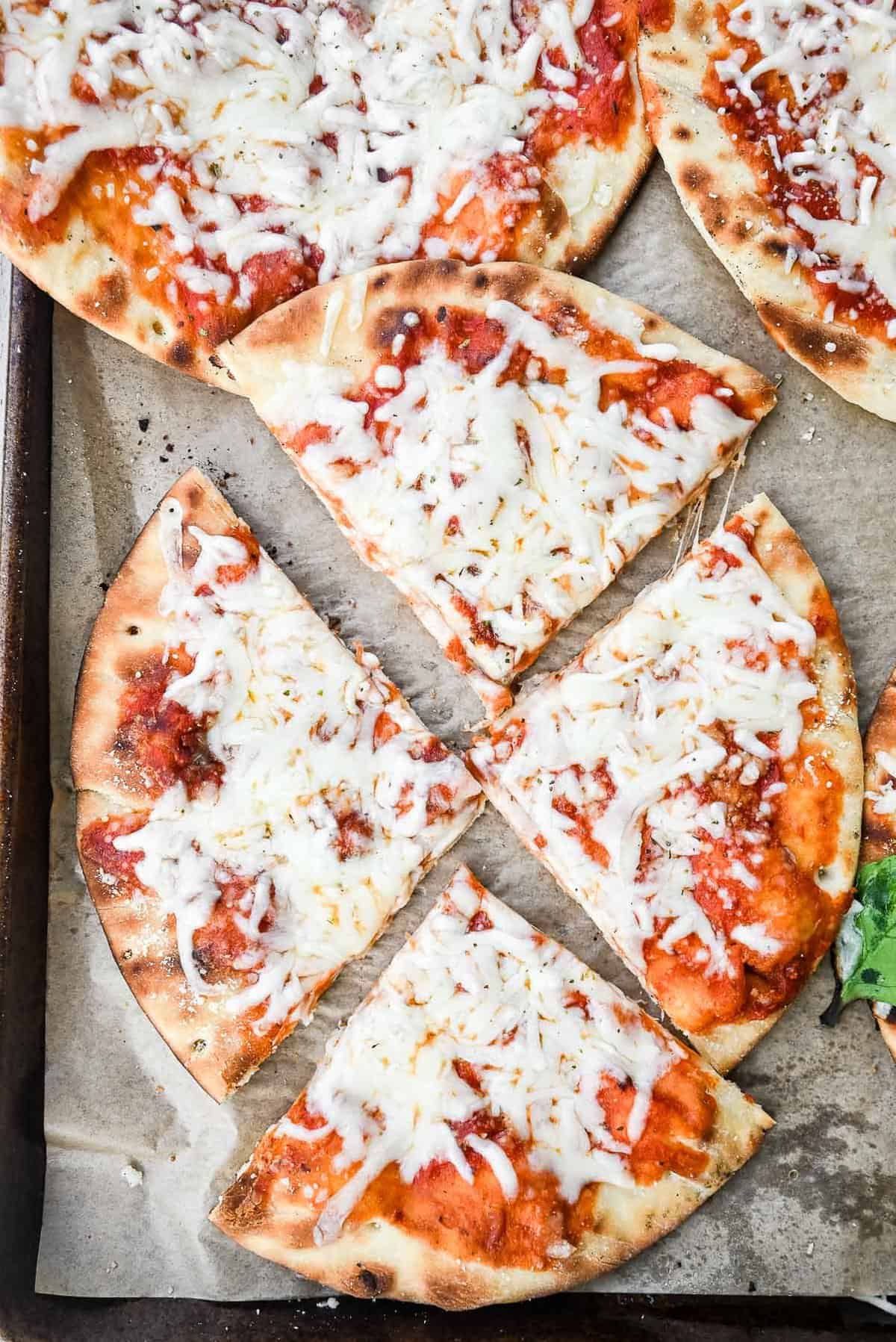 slices of cheese pizza on a sheet pan.
