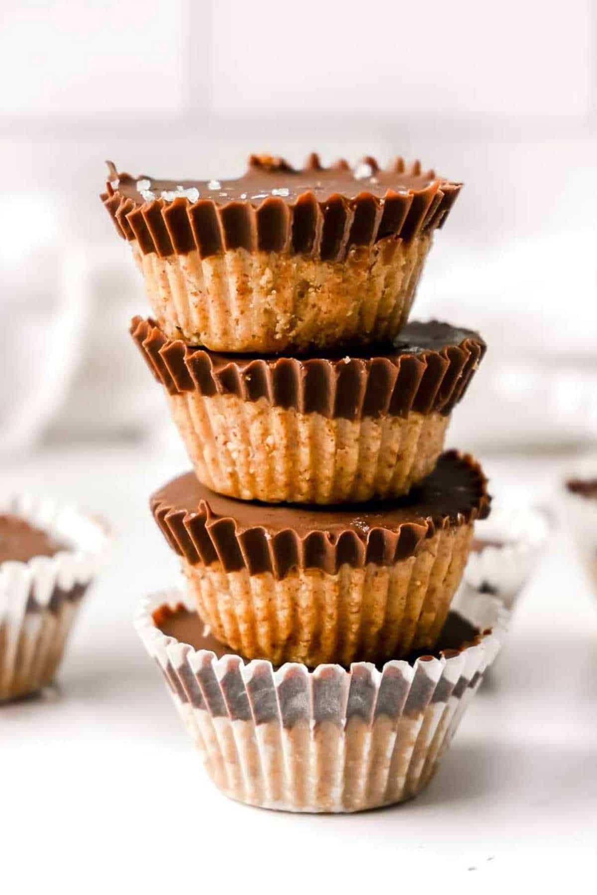 stack of four peanut butter cups in front of a white background.