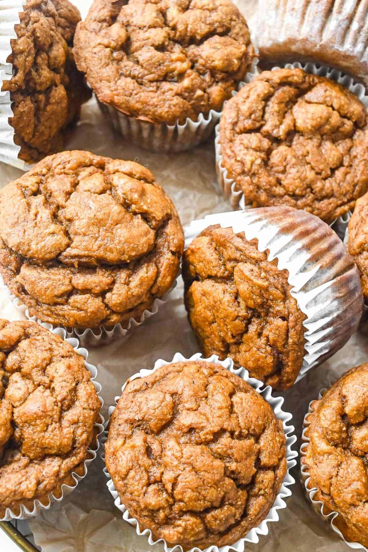 pumpkin banana muffins on brown parchment paper.