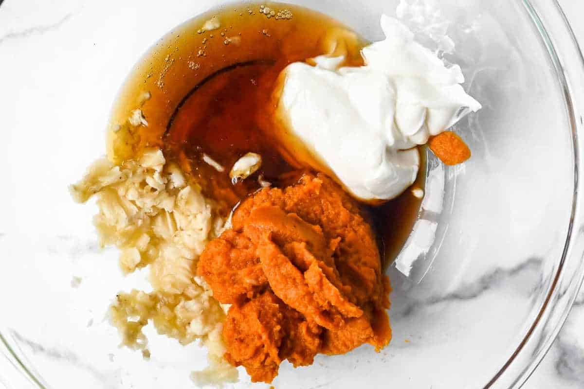 wet ingredients for pumpkin banana muffins in a glass bowl.