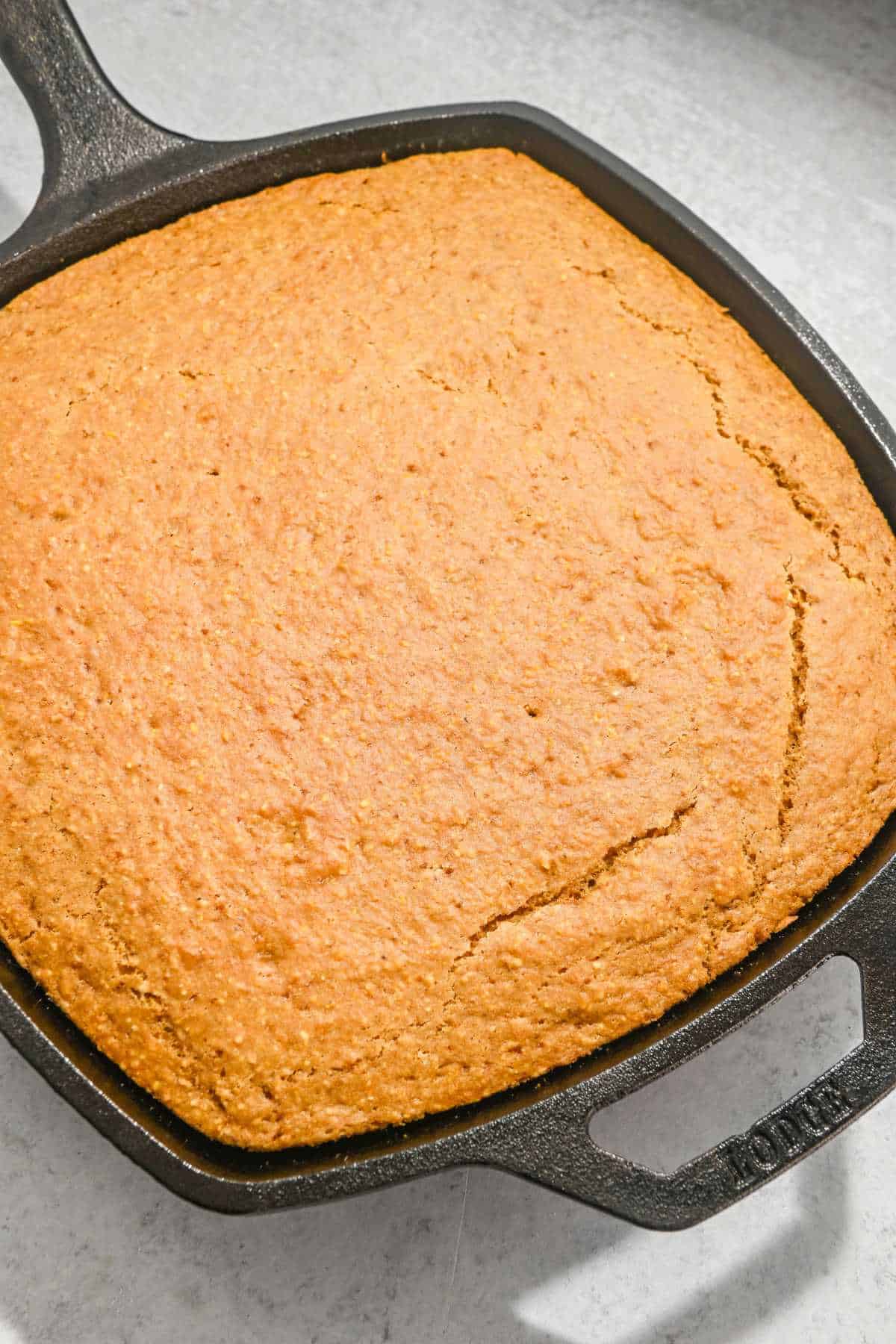 dairy-free cornbread in a square cast iron skillet.