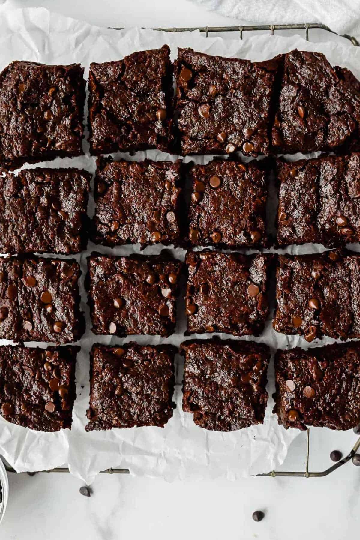 eggless brownies on a cooling rack on parchment paper.