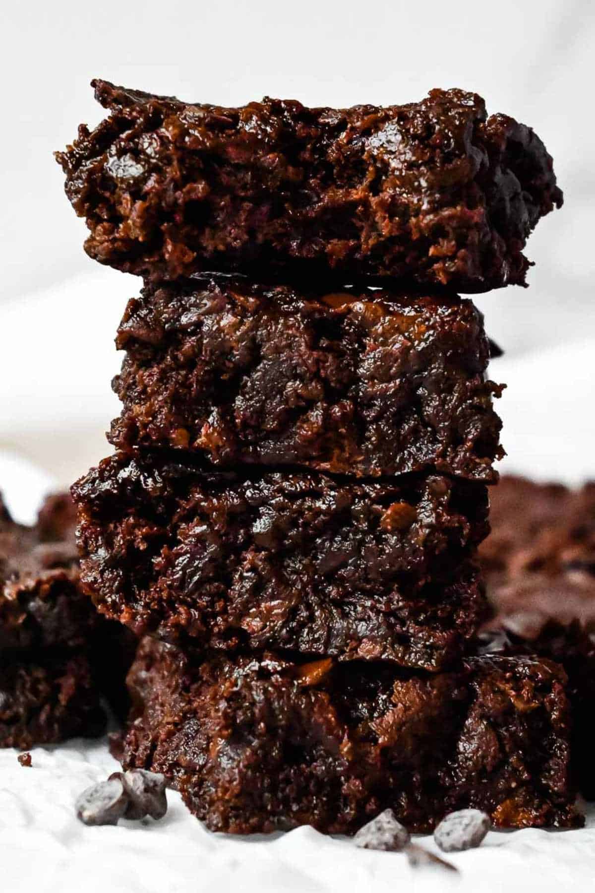 stack of eggless brownies, one with a bite taken out.