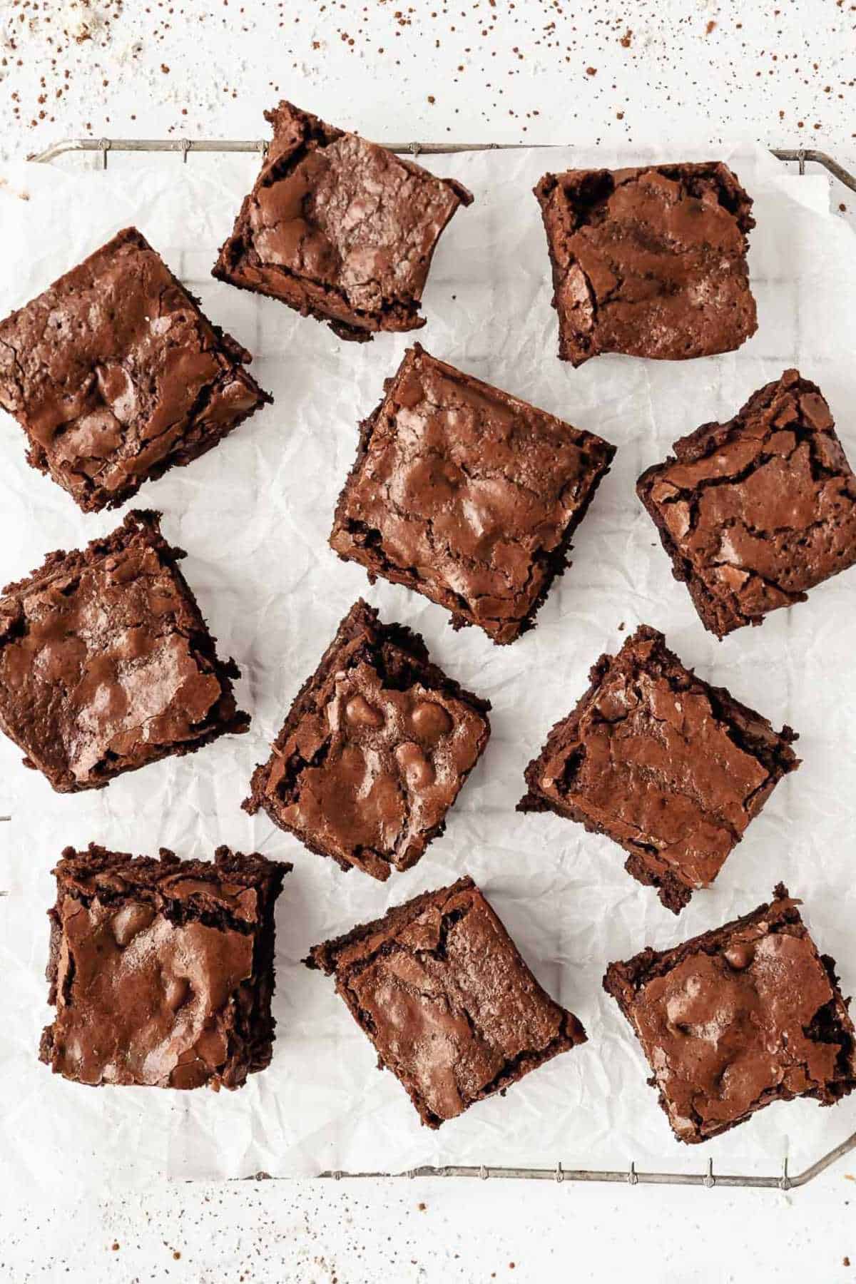 top down shot of oat flour brownies on a cooling rack on parchment paper.