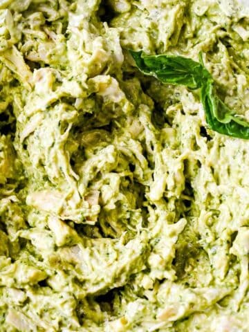 close up of basil pesto chicken salad in a bowl.