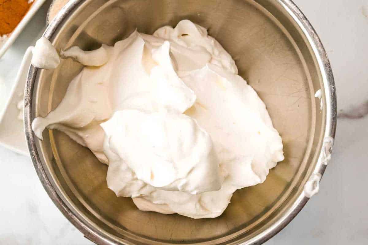 whipped cream in a silver bowl.