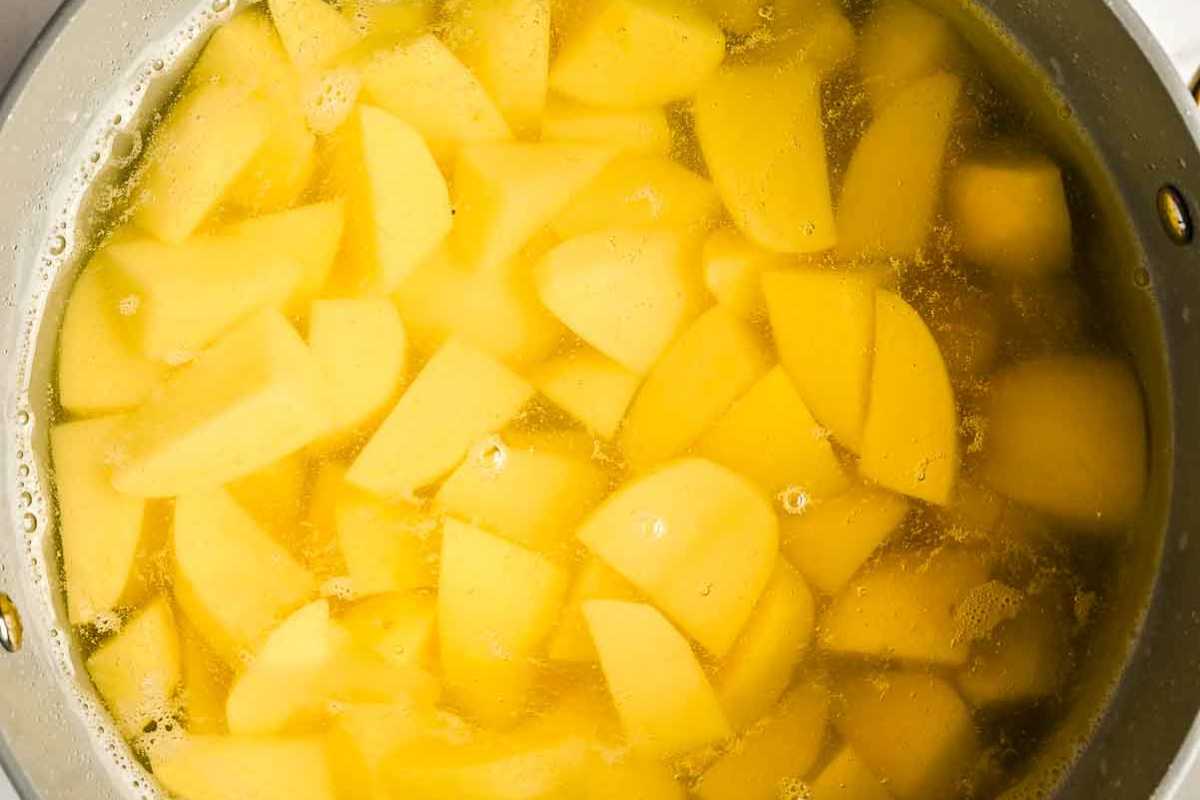 potatoes in water in a pot.