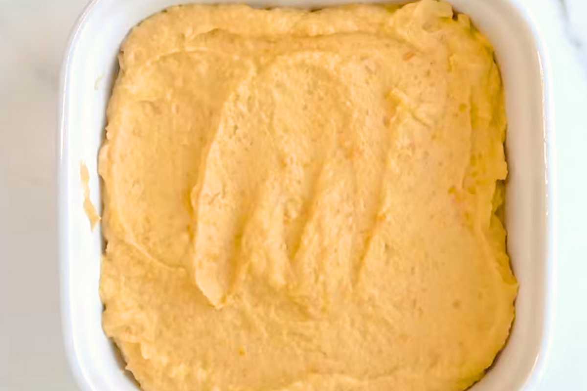 sweet potato souffle in a white baking dish on a white background.