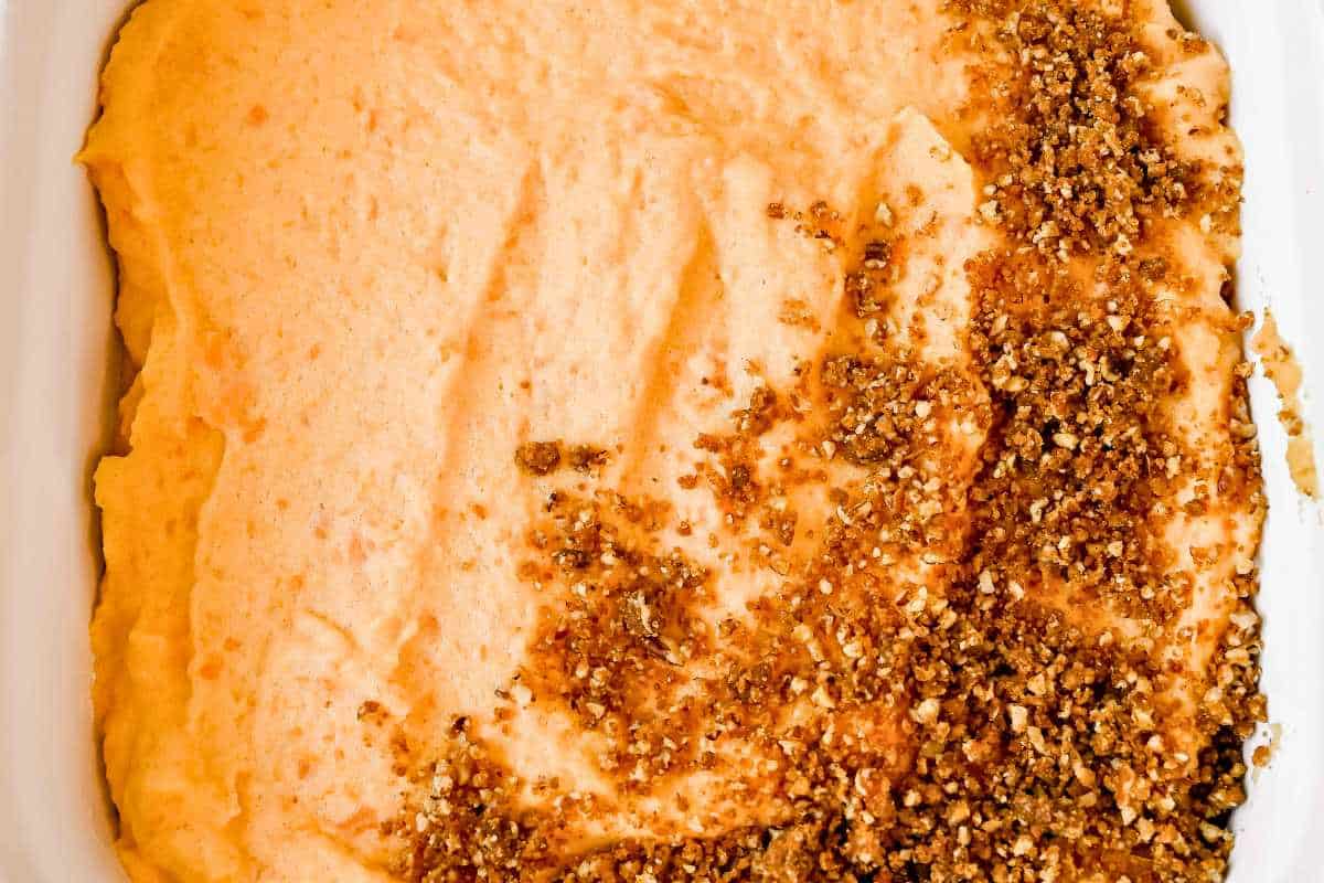 pecan crust half covering sweet potato souffle.